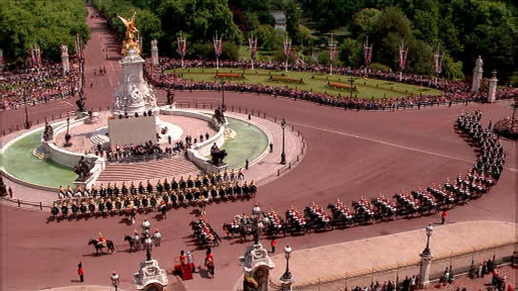 The Household Cavalry walk past The Queen outside the Palace
